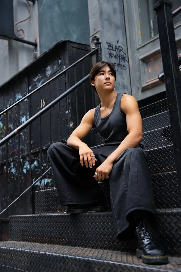 Man sitting on cast-iron stairs in SoHo