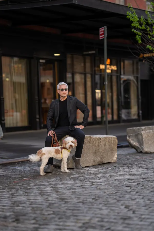 Man with his dog on a SoHo cobblestone street
