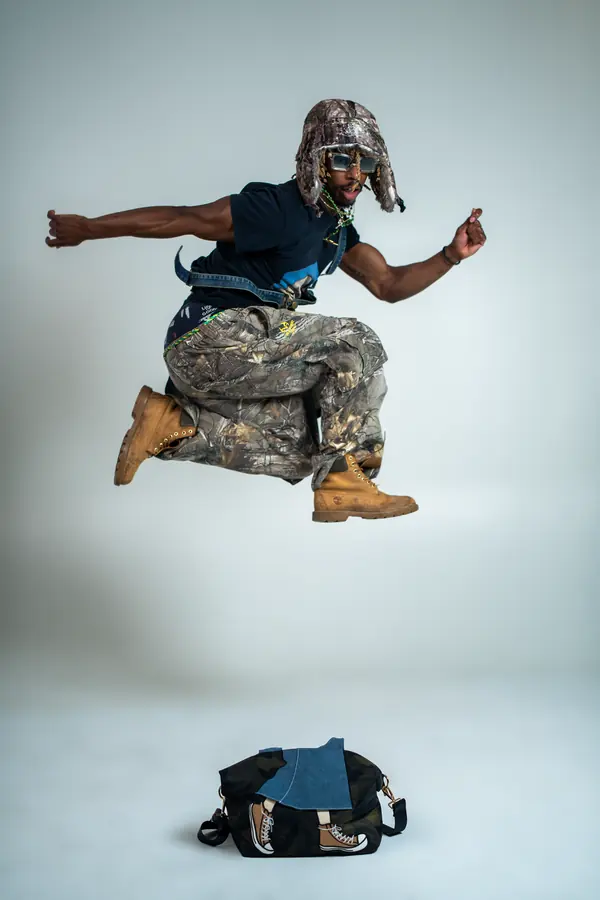 Dancer mid-leap on a white studio backdrop